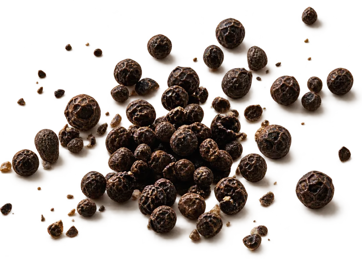 Cracked black peppercorns scattered across the frame